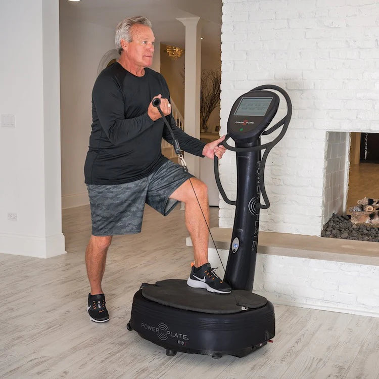 A man exercising on a Power Plate vibration machine